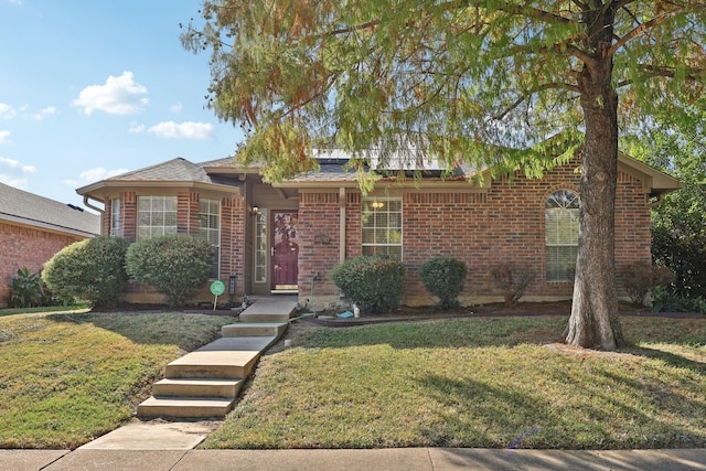 view of front of property featuring a front lawn and brick siding
