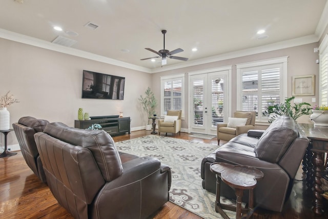 living area with french doors, a ceiling fan, visible vents, and crown molding