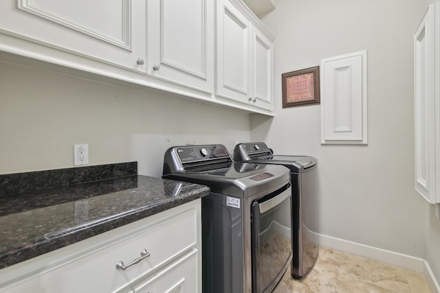 laundry room with washing machine and clothes dryer, cabinet space, and baseboards