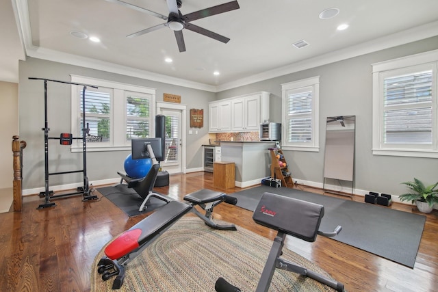 workout area featuring ceiling fan, visible vents, wood finished floors, and wine cooler