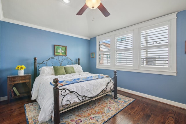 bedroom with lofted ceiling, wood finished floors, baseboards, and a ceiling fan