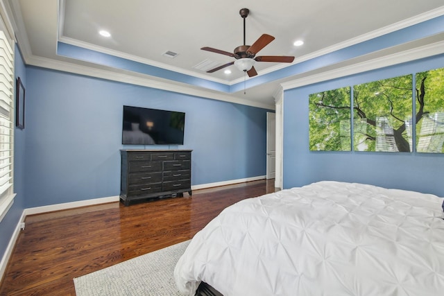 bedroom featuring wood finished floors, visible vents, a ceiling fan, crown molding, and baseboards