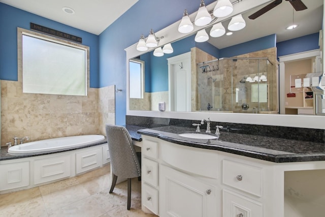 full bath featuring a garden tub, a stall shower, vanity, tile walls, and ceiling fan