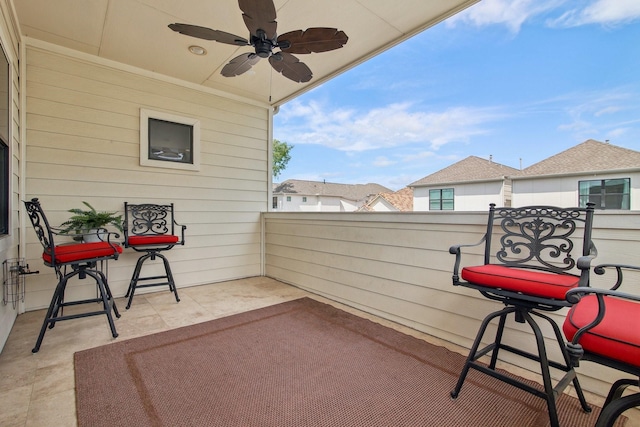 view of patio featuring ceiling fan and a balcony