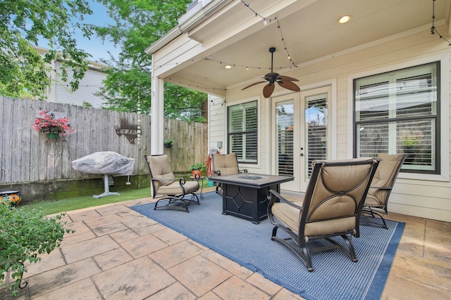 view of patio featuring ceiling fan, an outdoor fire pit, and fence