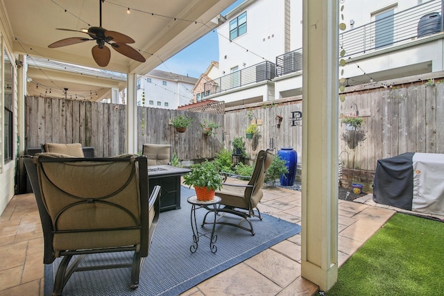view of patio with grilling area, a fenced backyard, and ceiling fan