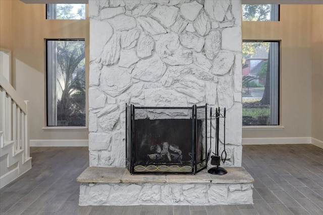 interior details featuring baseboards, wood finished floors, and a fireplace