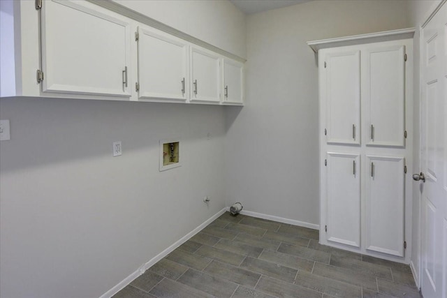washroom featuring hookup for a gas dryer, baseboards, washer hookup, and cabinet space