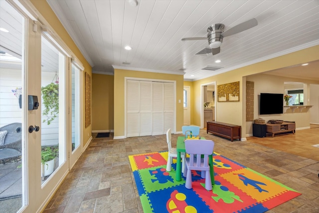 playroom featuring baseboards, visible vents, ornamental molding, and ceiling fan