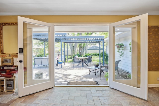 entryway featuring stone tile flooring and ornamental molding