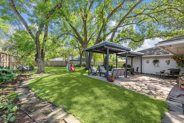 view of yard featuring a fenced backyard, outdoor lounge area, and a patio area