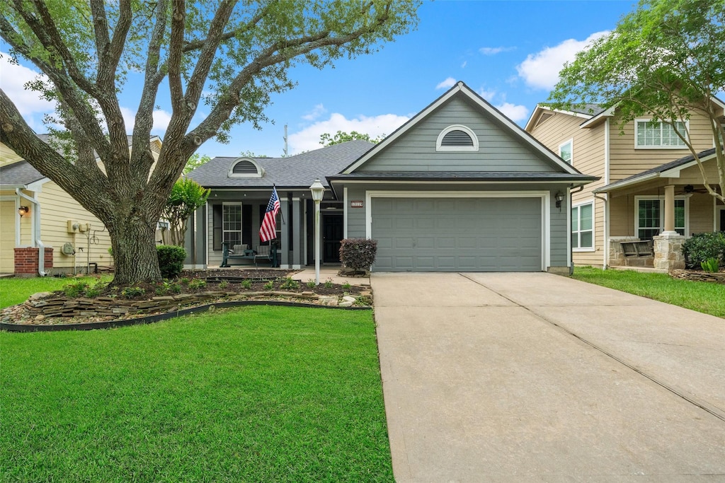 13119 Vivienne Westmoreland Dr, Cypress, TX 77429 - view of front of property featuring a front lawn, a garage, concrete driveway, and a shingled roof