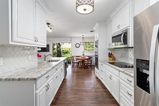 kitchen featuring white cabinets, dark wood-style floors, stainless steel appliances, and a sink