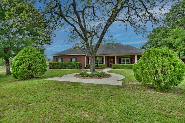 single story home with a front lawn and brick siding