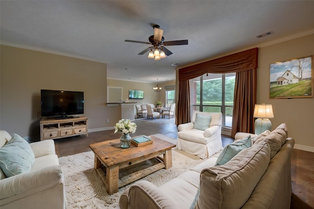 living area with visible vents, crown molding, baseboards, and ceiling fan with notable chandelier