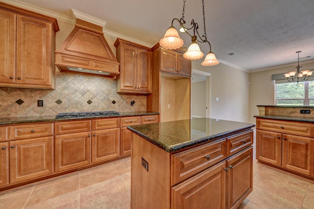 324 Howard St, Sealy, TX 77474 - kitchen featuring stainless steel gas stovetop, custom exhaust hood, dark stone counters, light tile patterned floors, and tasteful backsplash
