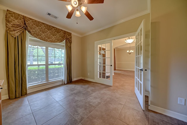 tiled empty room featuring visible vents, ornamental molding, french doors, baseboards, and ceiling fan with notable chandelier