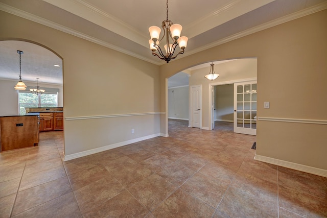 tiled spare room featuring a notable chandelier, arched walkways, french doors, baseboards, and ornamental molding