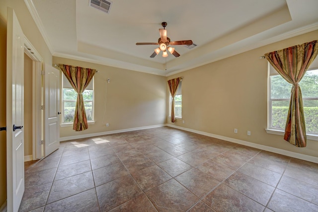 unfurnished room featuring visible vents, baseboards, a tray ceiling, and ceiling fan