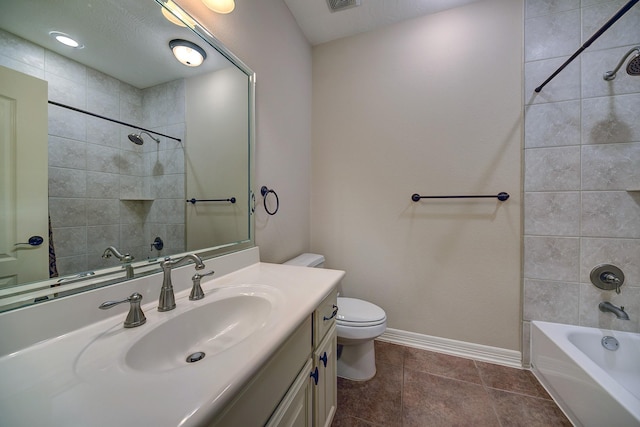 bathroom with tile patterned floors, vanity,  shower combination, baseboards, and toilet