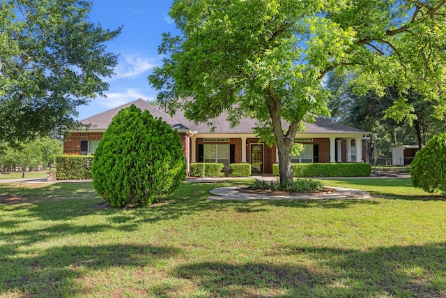 324 Howard St, Sealy, TX 77474 - view of front of home with brick siding and a front lawn
