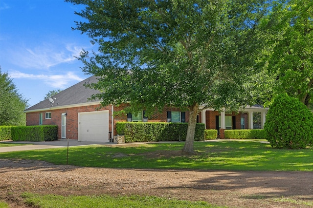 324 Howard St, Sealy, TX 77474 - obstructed view of property featuring driveway, a garage, and brick siding