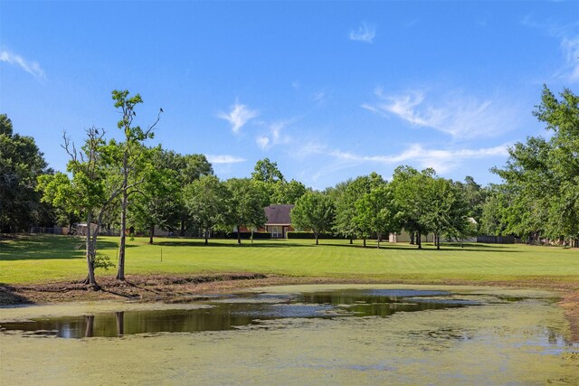 324 Howard St, Sealy, TX 77474 - view of property's community with a yard, a water view, and view of wooded area