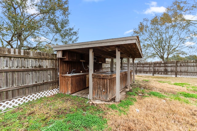 view of yard with a fenced backyard and a sink