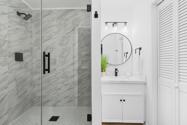 full bath with vanity and a shower stall
