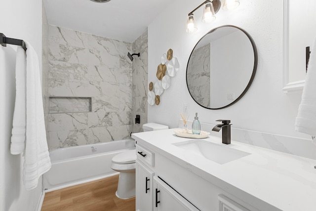 full bath with toilet, vanity, wood finished floors, and bathing tub / shower combination