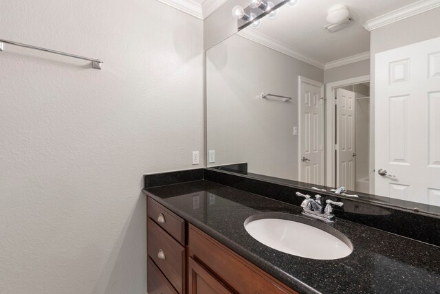 bathroom with crown molding, vanity, and visible vents