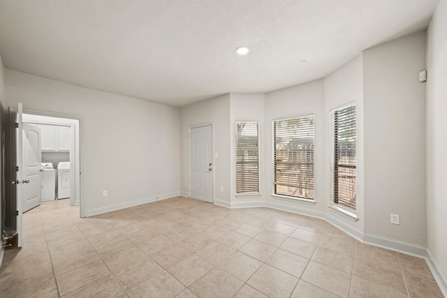 2905 Baer St Unit 3, Houston, TX 77020 - empty room featuring a textured ceiling, baseboards, recessed lighting, independent washer and dryer, and light tile patterned floors