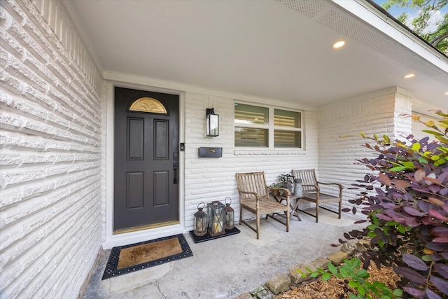 view of exterior entry featuring a porch