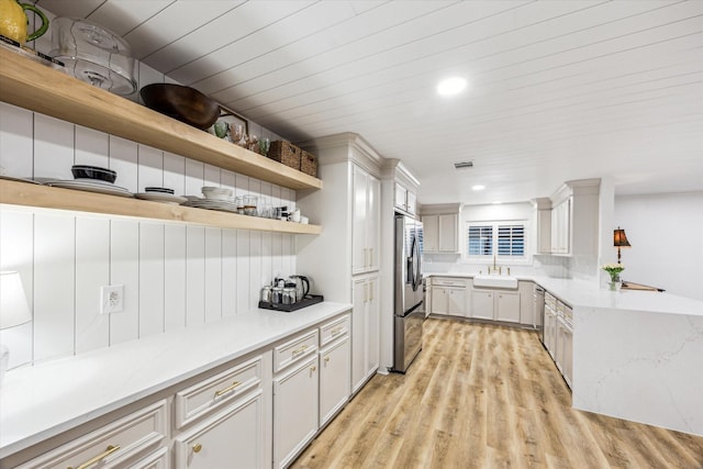 kitchen featuring light countertops, light wood finished floors, and appliances with stainless steel finishes