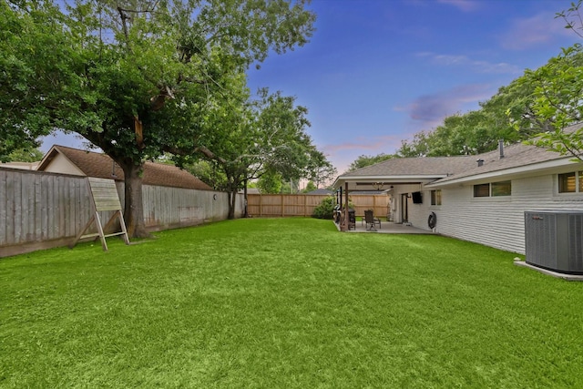 view of yard featuring central AC, a patio area, and a fenced backyard