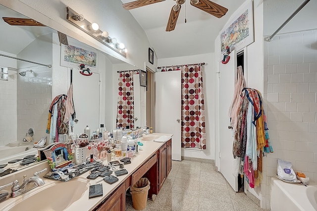 bathroom featuring washtub / shower combination, lofted ceiling, double vanity, a sink, and ceiling fan