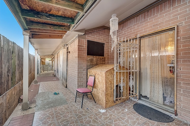 exterior space with fence and brick siding