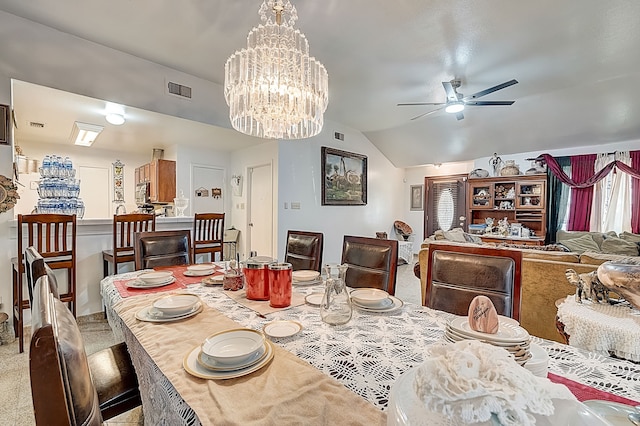dining room featuring vaulted ceiling, visible vents, carpet, and ceiling fan with notable chandelier