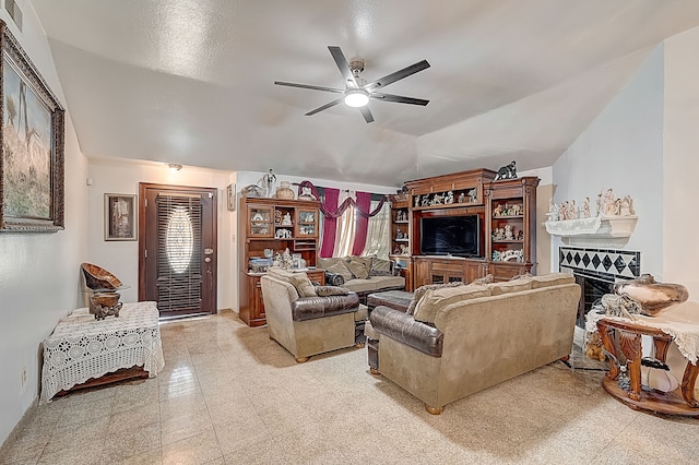 living area with vaulted ceiling, light floors, ceiling fan, a fireplace, and visible vents
