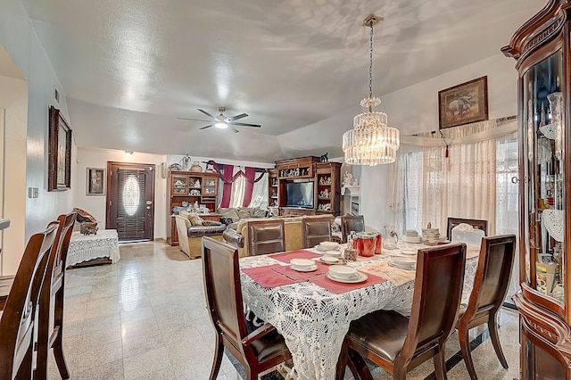 dining room featuring vaulted ceiling, visible vents, and ceiling fan with notable chandelier