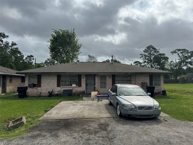 2602 Dalview St, Houston, TX 77091 - view of front of home with a front yard, brick siding, and roof with shingles