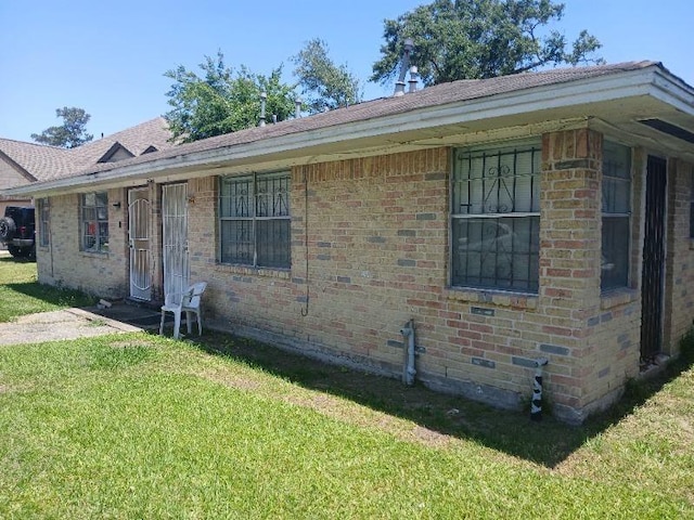 2602 Dalview St, Houston, TX 77091 - view of front of house featuring a front yard, brick siding, and a shingled roof