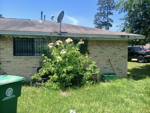 2602 Dalview St, Houston, TX 77091 - view of side of property featuring brick siding, a yard, and a shingled roof