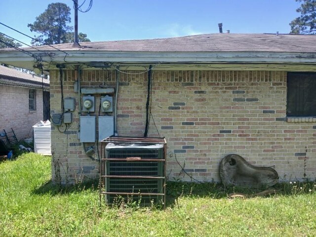 2602 Dalview St, Houston, TX 77091 - view of home's exterior with central air condition unit, brick siding, and roof with shingles