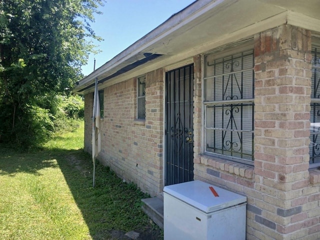 2602 Dalview St, Houston, TX 77091 - view of side of property with brick siding and a lawn
