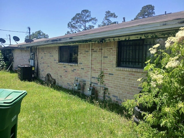 2602 Dalview St, Houston, TX 77091 - view of property exterior with central air condition unit, a lawn, and brick siding