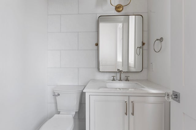 bathroom with toilet and vanity