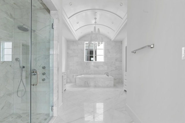 bathroom featuring marble finish floor, a bath, baseboards, a stall shower, and a notable chandelier