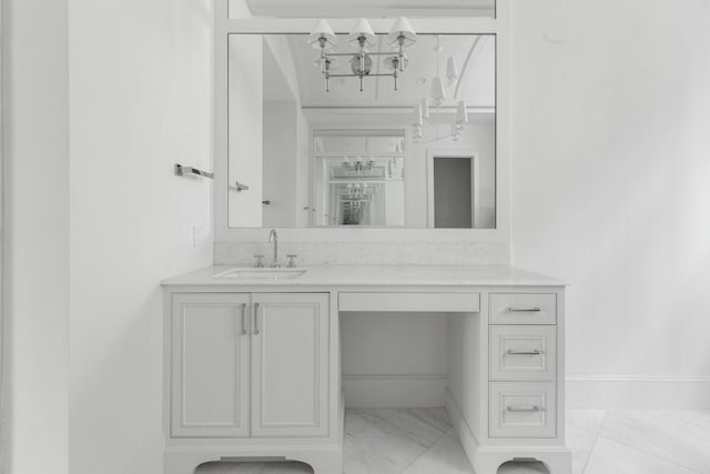 bathroom featuring baseboards, marble finish floor, and vanity