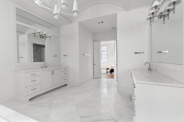 full bathroom featuring baseboards, marble finish floor, a sink, and a notable chandelier